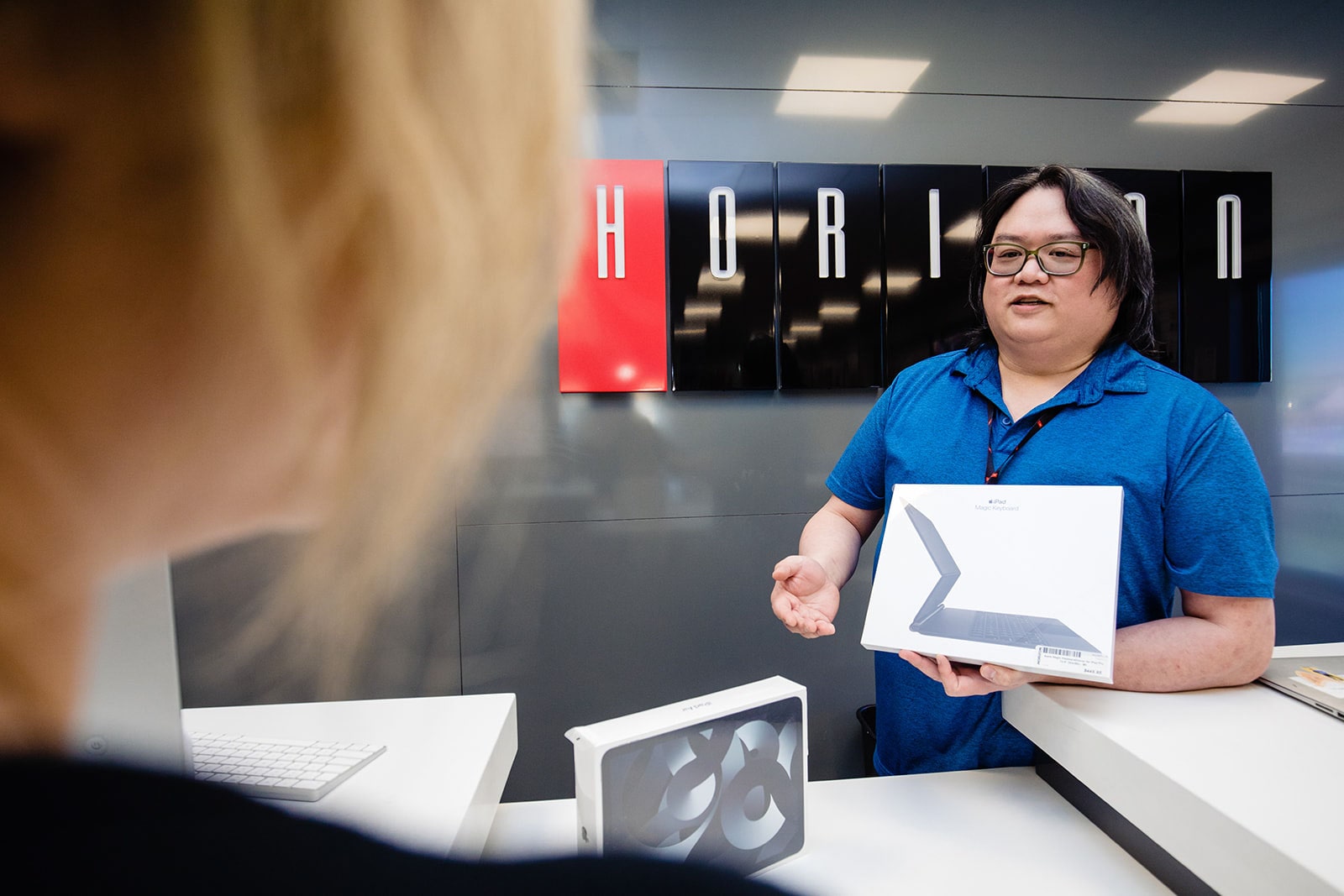 A service representative shows a client the latest products.